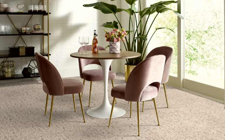 a plush beige patterned carpet in modern room with rose gold, pink accents
